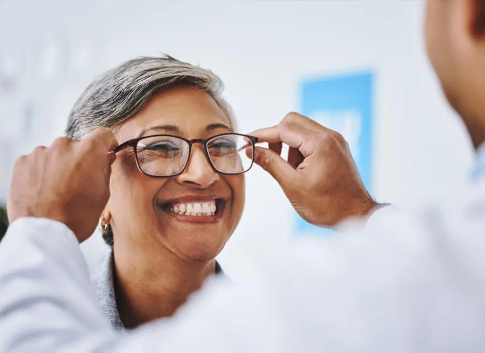 Woman being fitted in glasses prepares for cataract surgery as offered by Dr. Michael Merkley in Boise, Idaho