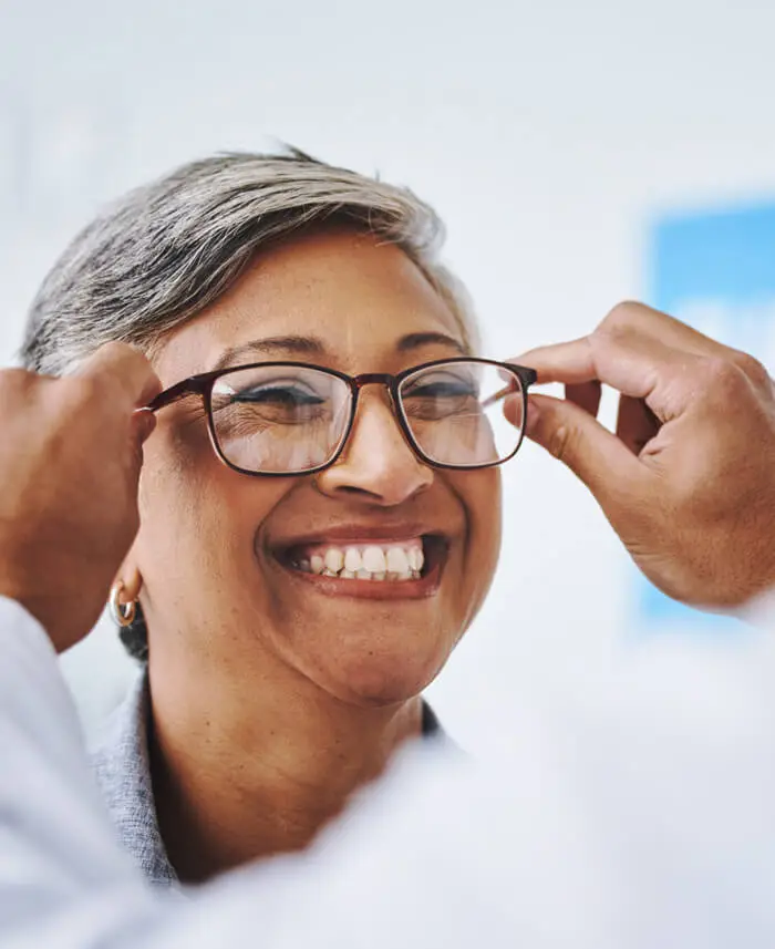 Woman being fitted in glasses prepares for cataract surgery as offered by Dr. Michael Merkley in Boise, Idaho